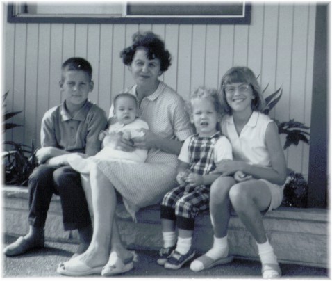 Left to right: Mark, Monica (in my mother's lap), Rick and me.