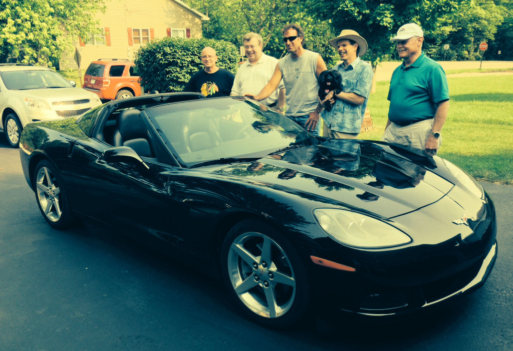 The guys bond next to Jeff's Corvette.