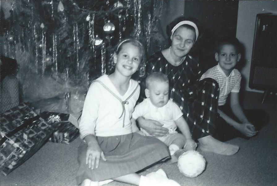 I was nine years old, and my baby brother, Rick, had just celebrated his first birthday when this photo was taken. I'm wearing a sailor-style knit top with a pleated skirt, along with a pair of white sneakers. It's Christmas, a little too cool--even in California--for my other brother to wear his Lederhosen. But they got a workout every summer!