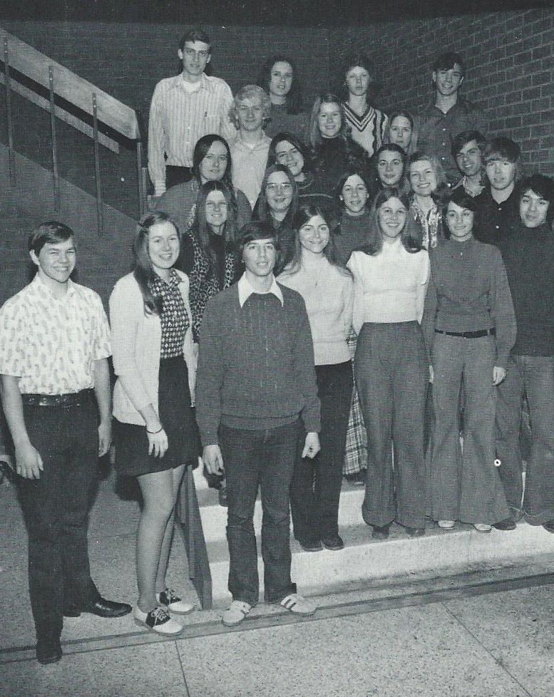 This is my high school newspaper staff, of which I was one of the editors. On the bottom stair are four students--three girls and one guy. I'm the second student from the left, wearing a pair of wool slacks to which I was allergic.