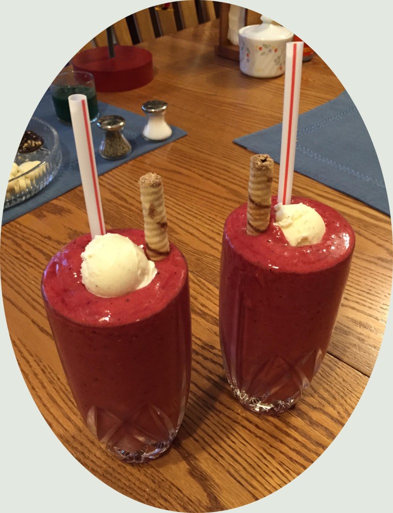 These glasses are a bit overfilled, but they didn't stay that way long. To make two full glasses, blend the following in your blender, using pulse/chop mode: 1 banana, 2 cups of orange juice, and 1 cup of frozen strawberries, and 1 cup of frozen raspberries or mixed berries. Top off with ice cream, and add a chocolate hazelnut "straw" for fun.